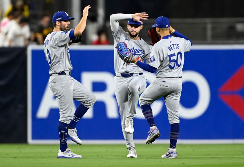 Oct 9, 2024; San Diego, California, USA; Los Angeles Dodgers outfielder Chris Taylor (3), outfielder Andy Pages (44) and shortstop Mookie Betts (50) celebrate after winning game four of the NLDS for the 2024 MLB Playoffs against the San Diego Padres at Petco Park.  Mandatory Credit: Denis Poroy-Imagn Images