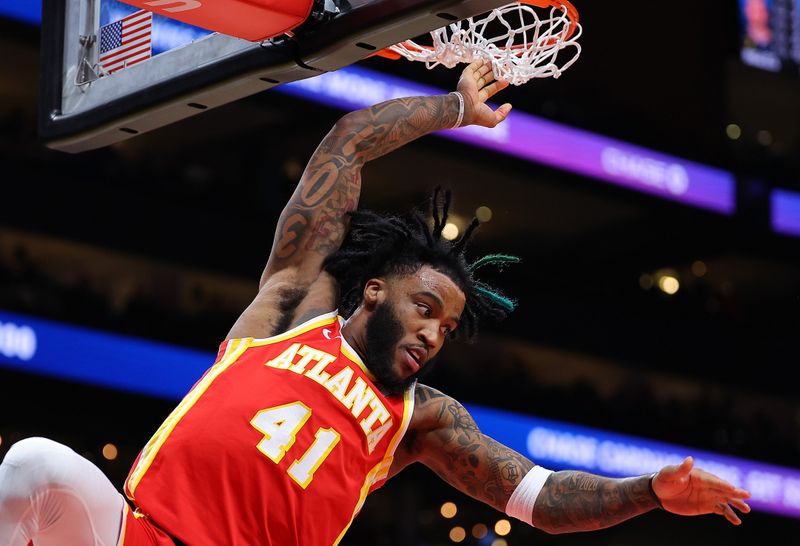 ATLANTA, GEORGIA - FEBRUARY 25:  Saddiq Bey #41 of the Atlanta Hawks dunks against the Orlando Magic during the fourth quarter at State Farm Arena on February 25, 2024 in Atlanta, Georgia.  NOTE TO USER: User expressly acknowledges and agrees that, by downloading and/or using this photograph, user is consenting to the terms and conditions of the Getty Images License Agreement.  (Photo by Kevin C. Cox/Getty Images)