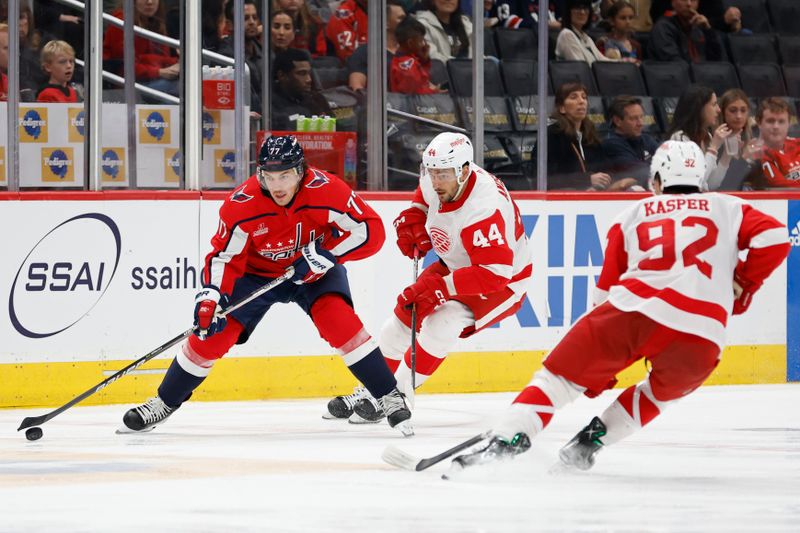 Sep 28, 2023; Washington, District of Columbia, USA; Washington Capitals right wing T.J. Oshie (77) skates with the puck as Detroit Red Wings defenseman Artem Anisimov (44) chases in the third period at Capital One Arena. Mandatory Credit: Geoff Burke-USA TODAY Sports