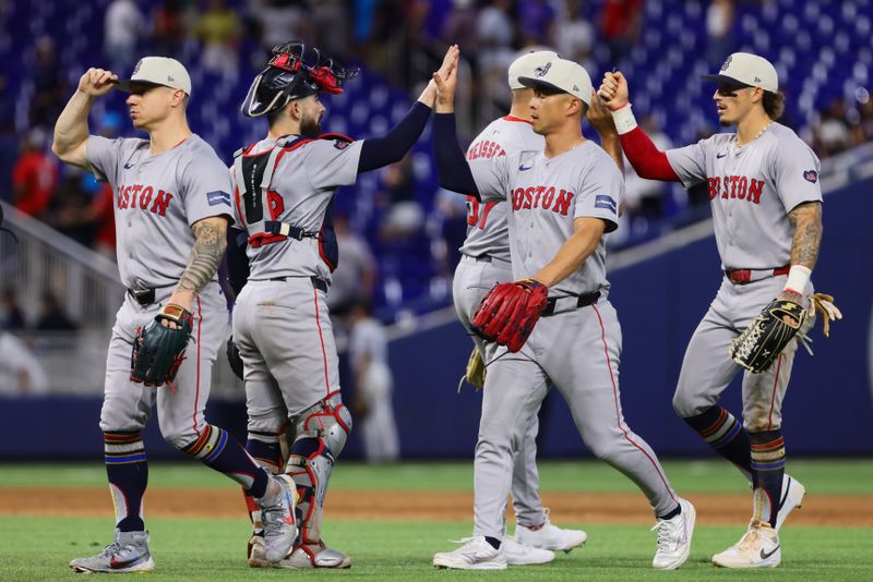 Jul 4, 2024; Miami, Florida, USA; Boston Red Sox left fielder Rob Refsnyder (30) celebrates with teammates after the game against the Miami Marlins at loanDepot Park. Mandatory Credit: Sam Navarro-USA TODAY Sports