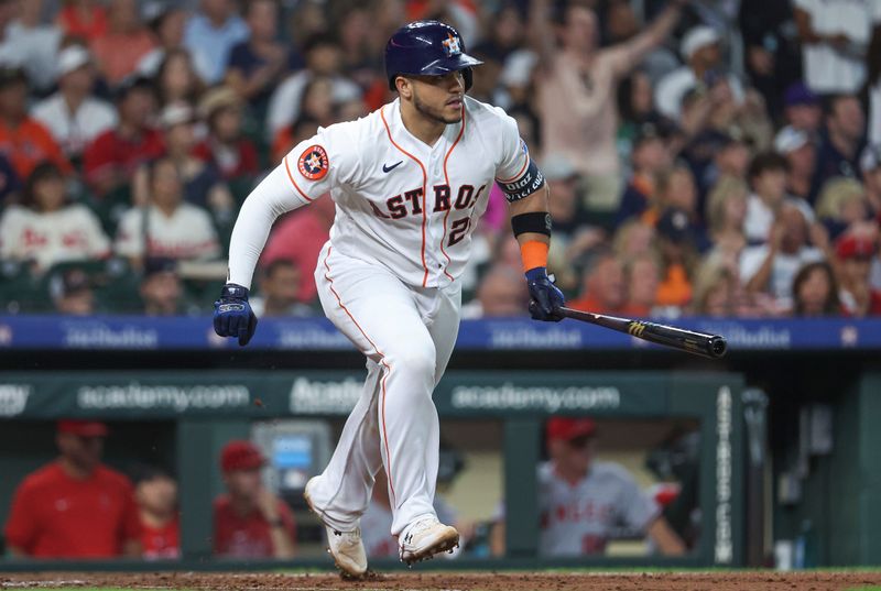 Aug 12, 2023; Houston, Texas, USA; Houston Astros catcher Yainer Diaz (21) hits an RBI single during the fifth inning against the Los Angeles Angels at Minute Maid Park. Mandatory Credit: Troy Taormina-USA TODAY Sports