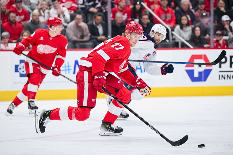 Feb 27, 2025; Detroit, Michigan, USA; Detroit Red Wings defenseman Simon Edvinsson (77) brings the puck up ice during the first period against the Columbus Blue Jackets at Little Caesars Arena. Mandatory Credit: Tim Fuller-Imagn Images