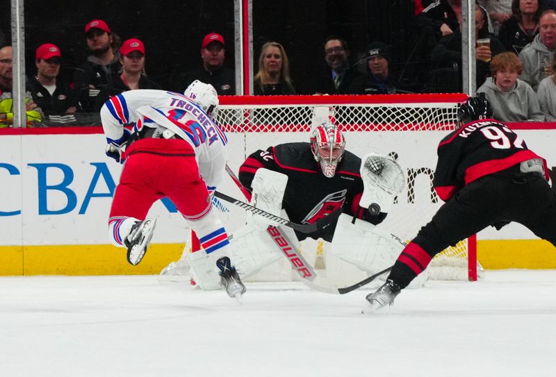 Mar 12, 2024; Raleigh, North Carolina, USA; Carolina Hurricanes goaltender Pyotr Kochetkov (52) stops the scoring attempt by New York Rangers center Vincent Trocheck (16) during the first period at PNC Arena. Mandatory Credit: James Guillory-USA TODAY Sports