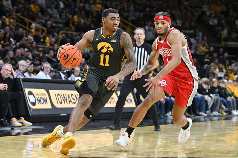 Feb 2, 2024; Iowa City, Iowa, USA; Iowa Hawkeyes guard Tony Perkins (11) goes to the basket as Ohio State Buckeyes guard Roddy Gayle Jr. (1) defends during the second half at Carver-Hawkeye Arena. Mandatory Credit: Jeffrey Becker-USA TODAY Sports