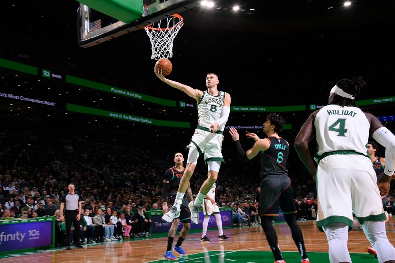 BOSTON, MA - FEBRUARY 9: Kristaps Porzingis #8 of the Boston Celtics drives to the basket during the game against the Washington Wizards on February 9, 2024 at the TD Garden in Boston, Massachusetts. NOTE TO USER: User expressly acknowledges and agrees that, by downloading and or using this photograph, User is consenting to the terms and conditions of the Getty Images License Agreement. Mandatory Copyright Notice: Copyright 2024 NBAE  (Photo by Brian Babineau/NBAE via Getty Images)