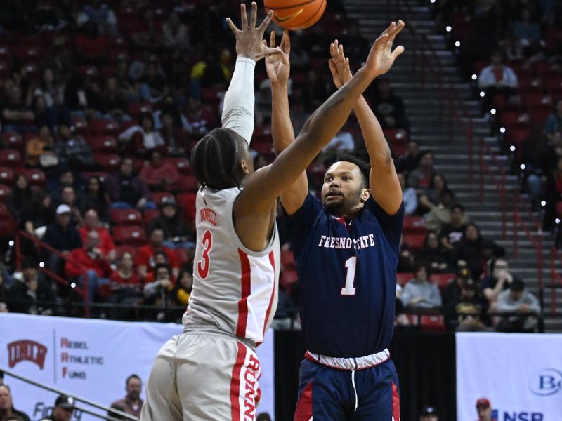 Feb 3, 2023; Las Vegas, Nevada, USA; Fresno State Bulldogs guard Jermarl Baker (1) scores on UNLV Runnin' Rebels guard Shane Nowell (3) in the second half at Thomas & Mack Center. Mandatory Credit: Candice Ward-USA TODAY Sports