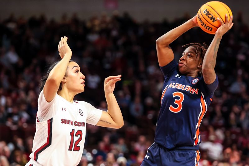 Jan 5, 2023; Columbia, South Carolina, USA; Auburn Tigers guard Jakayla Johnson (3) shoots over South Carolina Gamecocks guard Brea Beal (12) in the second half at Colonial Life Arena. Mandatory Credit: Jeff Blake-USA TODAY Sports