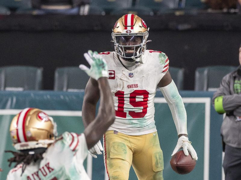 San Francisco 49ers wide receiver Deebo Samuel (19) catches a pass, runs for a touchdown,and celebrates with teammate Brandon Aiyuk (11) against the Philadelphia Eagles in an NFL football game, Sunday, Dec. 3, 2023, in Philadelphia, PA. 49ers defeat the Eagles 42-19. (AP Photo/Jeff Lewis)