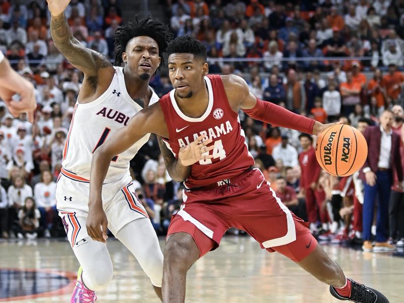 Feb 11, 2023; Auburn, Alabama, USA;  Alabama Crimson Tide forward Brandon Miller (24) drives past Auburn Tigers guard Zep Jasper (12) at Neville Arena. Mandatory Credit: Julie Bennett-USA TODAY Sports

