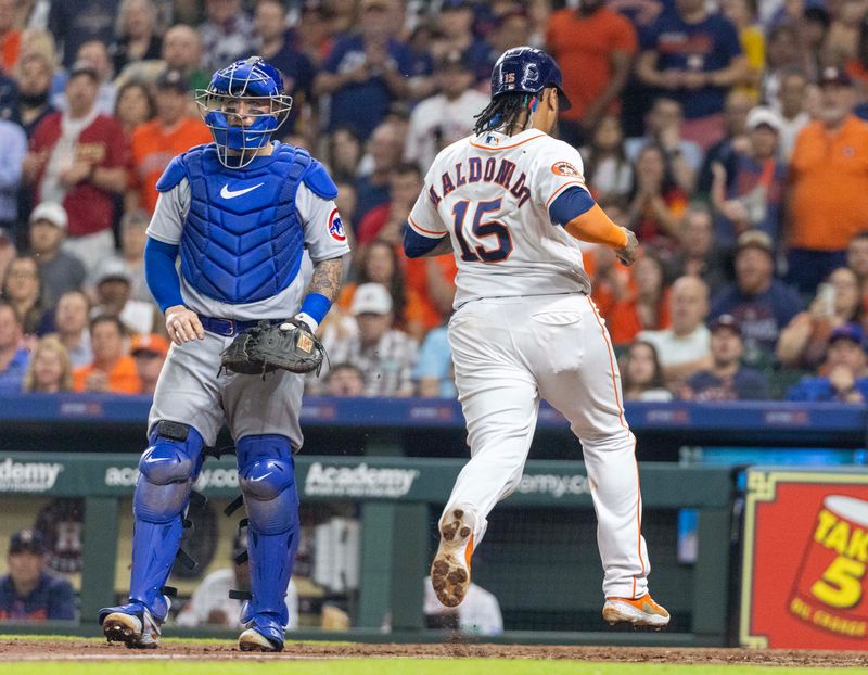 May 16, 2023; Houston, Texas, USA; Houston Astros catcher Martin Maldonado (15) scores on Houston Astros third baseman Alex Bregman (2) (not pictured) sacrifice RBI against the Chicago Cubs in the seventh inning at Minute Maid Park. Mandatory Credit: Thomas Shea-USA TODAY Sports