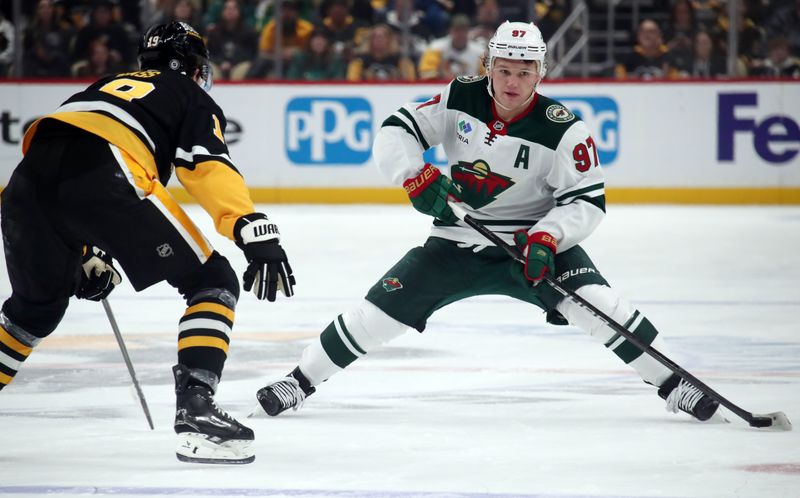 Oct 29, 2024; Pittsburgh, Pennsylvania, USA; Minnesota Wild left wing Kirill Kaprizov (97) skates with the puck as Pittsburgh Penguins center Cody Glass (19) defends during the second period at PPG Paints Arena. Mandatory Credit: Charles LeClaire-Imagn Images