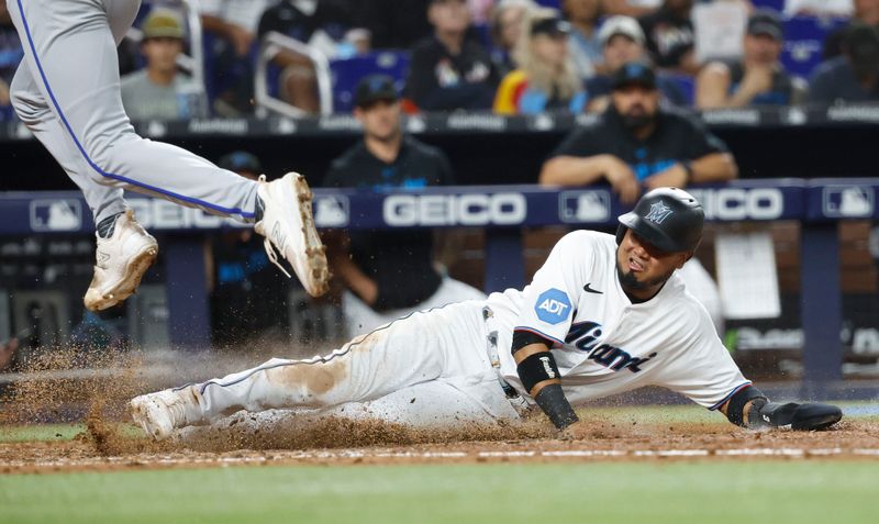 Jun 6, 2023; Miami, Florida, USA; Miami Marlins second baseman Luis Arraez (3) scores on a wild pitch against the Kansas City Royals during the seventh inning at loanDepot Park. Mandatory Credit: Rhona Wise-USA TODAY Sports