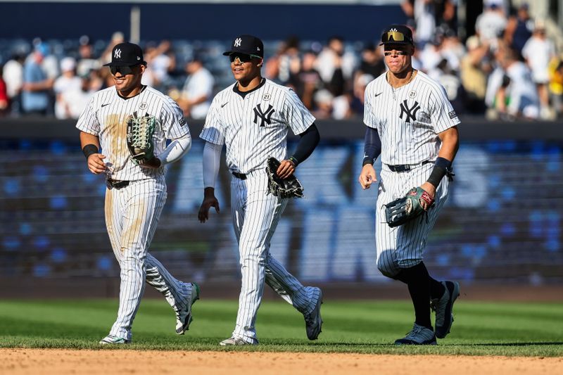 Sep 15, 2024; Bronx, New York, USA;  New York Yankees outfielders Jasson Domínguez (89), Juan Soto (22) and  Aaron Judge (99) walk off the field after defeating the Boston Red Sox 5-2 at Yankee Stadium. Mandatory Credit: Wendell Cruz-Imagn Images