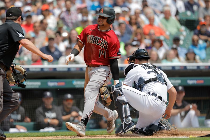 Jun 10, 2023; Detroit, Michigan, USA;  Arizona Diamondbacks catcher Gabriel Moreno (14) is tagged out by Detroit Tigers catcher Jake Rogers (34) in the second inning at Comerica Park. Mandatory Credit: Rick Osentoski-USA TODAY Sports