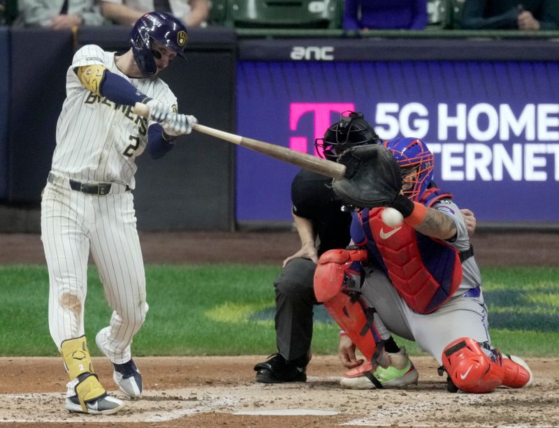 Oct 2, 2024; Milwaukee, Wisconsin, USA; Milwaukee Brewers second baseman Brice Turang (2) hits a double during the fifth inning in game two of their wild-card playoff game against the New York Mets at American Family Field. Mandatory Credit: Mark Hoffman-Imagn Images