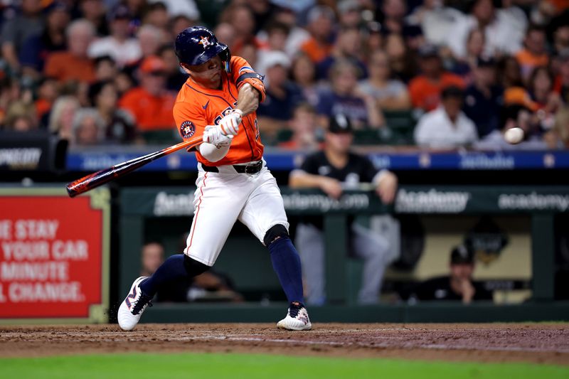 Aug 16, 2024; Houston, Texas, USA; Houston Astros second baseman Jose Altuve (27) hits a double to left field against the Chicago White Sox during the third inning at Minute Maid Park. Mandatory Credit: Erik Williams-USA TODAY Sports