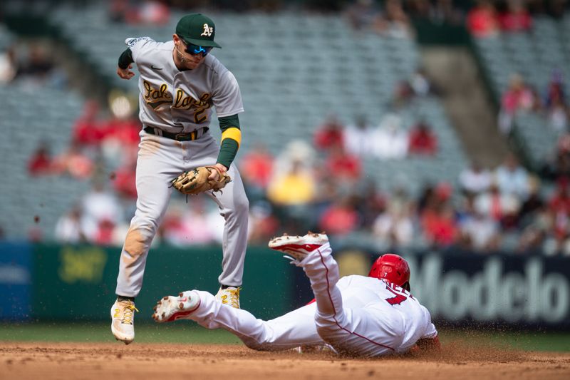 Oct 1, 2023; Anaheim, California, USA; Los Angeles Angels right fielder Jo Adell (7) steals second base against the Oakland Athletics shortstop Nick Allen (2) during the fourth inning at Angel Stadium. Mandatory Credit: Jonathan Hui-USA TODAY Sports