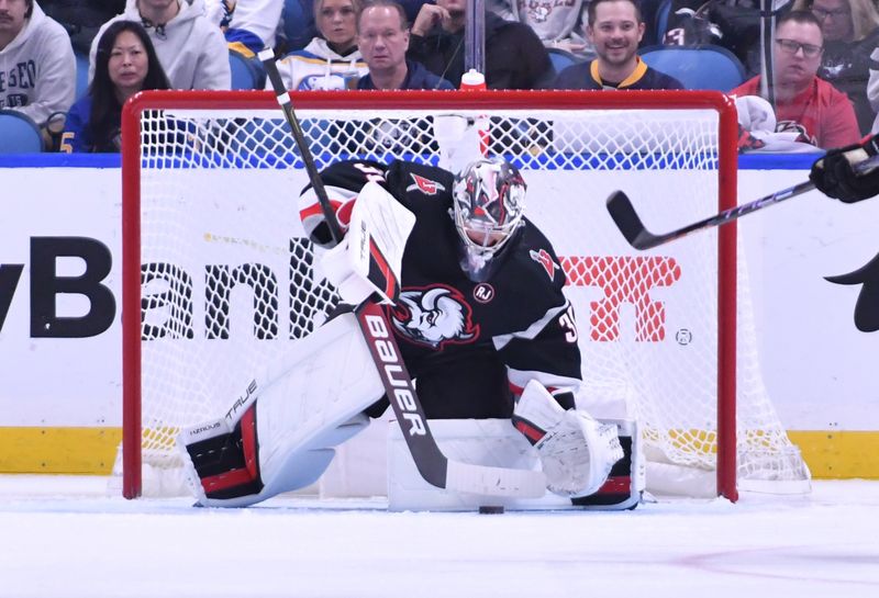 Oct 21, 2023; Buffalo, New York, USA; Buffalo Sabres goaltender Eric Comrie (31) makes a stop on the puck in the second period against the New York Islanders Lane Lambert () at KeyBank Center. Mandatory Credit: Mark Konezny-USA TODAY Sports