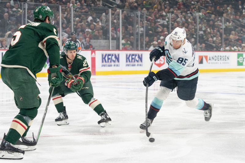 Apr 18, 2024; Saint Paul, Minnesota, USA; Seattle Kraken left wing Andre Burakovsky (95) shoots as Minnesota Wild defenseman Jake Middleton (5) goes to block a shot in the first period at Xcel Energy Center. Mandatory Credit: Matt Blewett-USA TODAY Sports