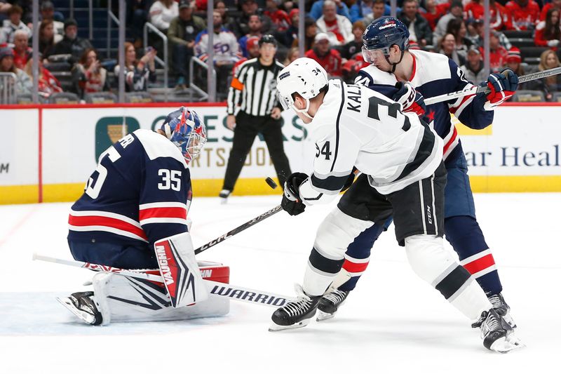 Jan 7, 2024; Washington, District of Columbia, USA; Los Angeles Kings right wing Arthur Kaliyev (34) shoots the puck against Washington Capitals goaltender Darcy Kuemper (35) during the first period at Capital One Arena. Mandatory Credit: Amber Searls-USA TODAY Sports