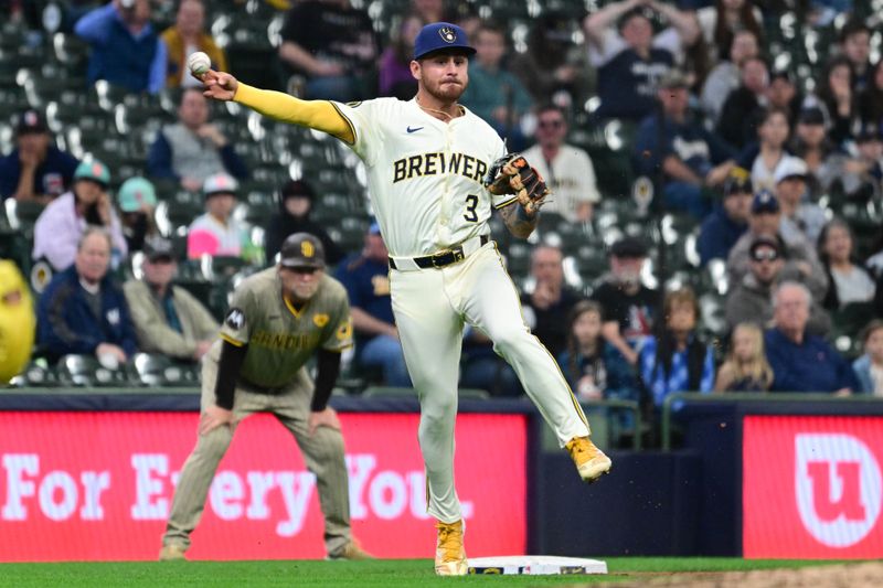 Apr 17, 2024; Milwaukee, Wisconsin, USA; Milwaukee Brewers third baseman Joey Ortiz (3) throws out San Diego Padres designated hitter Manny Machado (13) in the ninth inning at American Family Field. Mandatory Credit: Benny Sieu-USA TODAY Sports