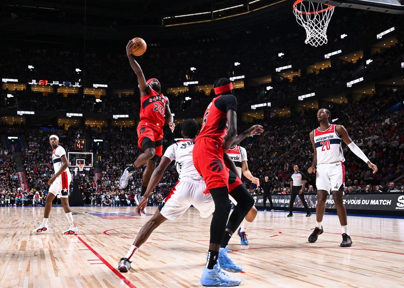 MONTREAL, CANADA - OCTOBER 06: Jamal Shead #23 of the Toronto Raptors jumps up with the ball during the first half of a preseason NBA game against the Washington Wizards at the Bell Centre on October 6, 2024 in Montreal, Quebec, Canada. NOTE TO USER: User expressly acknowledges and agrees that, by downloading and or using this photograph, User is consenting to the terms and conditions of the Getty Images License Agreement. (Photo by Minas Panagiotakis/Getty Images)