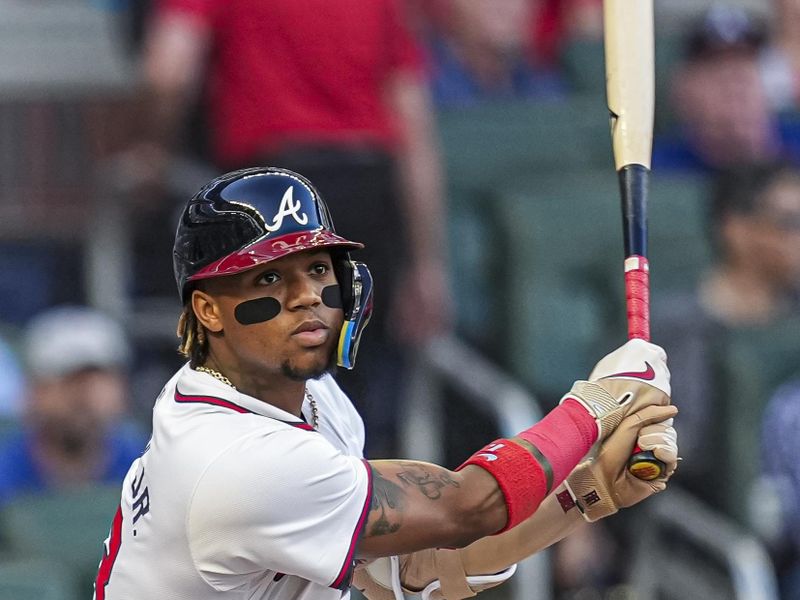 Apr 23, 2024; Cumberland, Georgia, USA; Atlanta Braves outfielder Ronald Acuna Jr. (13) doubles against the Miami Marlins during the first inning at Truist Park. Mandatory Credit: Dale Zanine-USA TODAY Sports