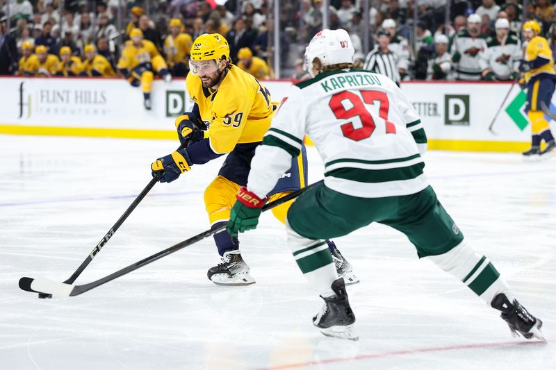 Nov 30, 2024; Saint Paul, Minnesota, USA; Nashville Predators defenseman Roman Josi (59) skates with the puck as Minnesota Wild left wing Kirill Kaprizov (97) defends during the first period at Xcel Energy Center. Mandatory Credit: Matt Krohn-Imagn Images