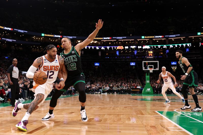 BOSTON, MASSACHUSETTS - FEBRUARY 03: Ish Wainright #12 of the Phoenix Suns drives to the basket against Grant Williams #12 of the Boston Celtics  at TD Garden on February 03, 2023 in Boston, Massachusetts. NOTE TO USER: User expressly acknowledges and agrees that, by downloading and or using this photograph, User is consenting to the terms and conditions of the Getty Images License Agreement. (Photo by Maddie Meyer/Getty Images)