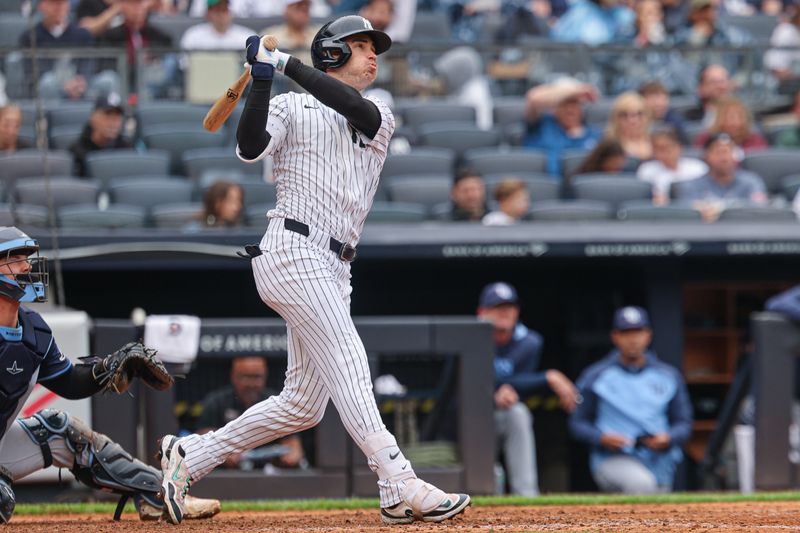 May 4, 2025; Bronx, New York, USA; New York Yankees left fielder Cody Bellinger (35) hits a two run home run during the sixth inning against the Tampa Bay Rays at Yankee Stadium. Mandatory Credit: Vincent Carchietta-Imagn Images