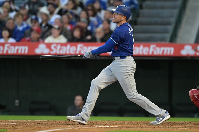 Mar 26, 2024; Anaheim, California, USA; Los Angeles Dodgers first baseman Freddie Freeman (5) hits a solo home run in the third inning against the Los Angeles Angels at Angel Stadium. Mandatory Credit: Jayne Kamin-Oncea-USA TODAY Sports