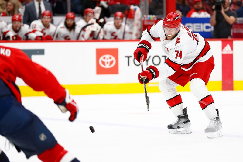 Mar 22, 2024; Washington, District of Columbia, USA; Carolina Hurricanes defenseman Jaccob Slavin (74) passes the puck against the Washington Capitals during the second period at Capital One Arena. Mandatory Credit: Amber Searls-USA TODAY Sports