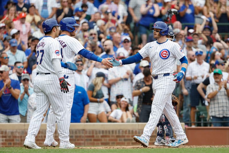 Jul 4, 2024; Chicago, Illinois, USA; Chicago Cubs outfielder Ian Happ (8) celebrates with outfielders Cody Bellinger (24) and Seiya Suzuki (27) after hitting a three-run home run against the Philadelphia Phillies during the fourth inning at Wrigley Field. Mandatory Credit: Kamil Krzaczynski-USA TODAY Sports