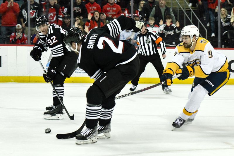 Apr 7, 2024; Newark, New Jersey, USA; New Jersey Devils defenseman Brendan Smith (2) receives a pass from New Jersey Devils left wing Tomas Nosek (92) as Nashville Predators left wing Filip Forsberg (9) defends during overtime at Prudential Center. Mandatory Credit: John Jones-USA TODAY Sports