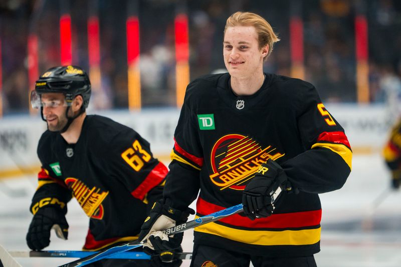 Oct 28, 2025; Vancouver, British Columbia, CAN; Making his NHL debut Vancouver Canucks defenseman Tom Willander (5) smiles during warm up prior to a game against the New York Rangers at Rogers Arena. Mandatory Credit: Bob Frid-Imagn Images