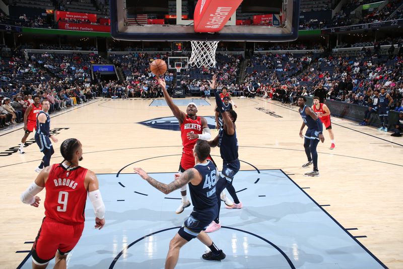 MEMPHIS, TN - FEBRUARY 14: Aaron Holiday #0 of the Houston Rockets drives to the basket during the game against the Memphis Grizzlies on February 14, 2024 at FedExForum in Memphis, Tennessee. NOTE TO USER: User expressly acknowledges and agrees that, by downloading and or using this photograph, User is consenting to the terms and conditions of the Getty Images License Agreement. Mandatory Copyright Notice: Copyright 2024 NBAE (Photo by Joe Murphy/NBAE via Getty Images)