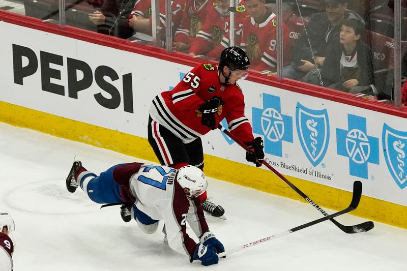 Feb 29, 2024; Chicago, Illinois, USA; Colorado Avalanche left wing Jonathan Drouin (27) defends Chicago Blackhawks defenseman Kevin Korchinski (55) during the first period at United Center. Mandatory Credit: David Banks-USA TODAY Sports