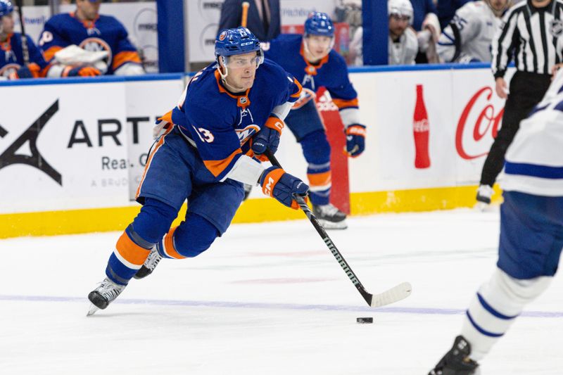 Dec 11, 2023; Elmont, New York, USA; New York Islanders center Mathew Barzal (13) skates with the puck against the Toronto Maple Leafs during the second period at UBS Arena. Mandatory Credit: Thomas Salus-USA TODAY Sports