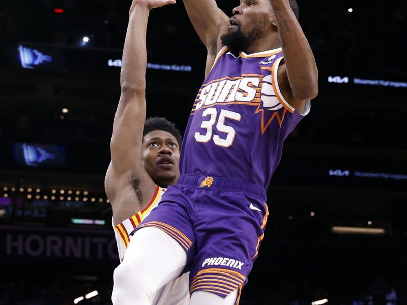 PHOENIX, ARIZONA - MARCH 21: Kevin Durant #35 of the Phoenix Suns shoots against De'Andre Hunter #12 of the Atlanta Hawks during the second half at Footprint Center on March 21, 2024 in Phoenix, Arizona. NOTE TO USER: User expressly acknowledges and agrees that, by downloading and or using this photograph, User is consenting to the terms and conditions of the Getty Images License Agreement.  (Photo by Chris Coduto/Getty Images)