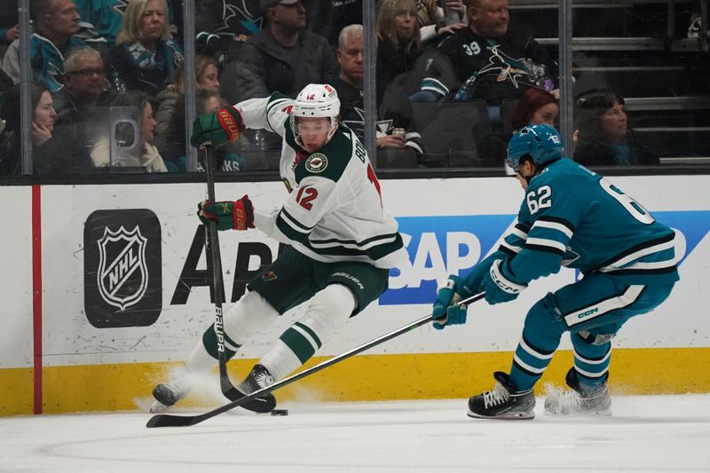 Apr 13, 2024; San Jose, California, USA; Minnesota Wild left wing Matt Boldy (12) controls the puck against San Jose Sharks right wing Kevin Labanc (62) during the fiirst period at SAP Center at San Jose. Mandatory Credit: David Gonzales-USA TODAY Sports