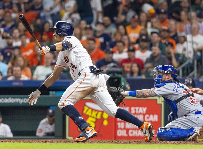 May 16, 2023; Houston, Texas, USA; Houston Astros second baseman Mauricio Dubon (14) hits a double against the Chicago Cubs in the seventh inning at Minute Maid Park. Mandatory Credit: Thomas Shea-USA TODAY Sports