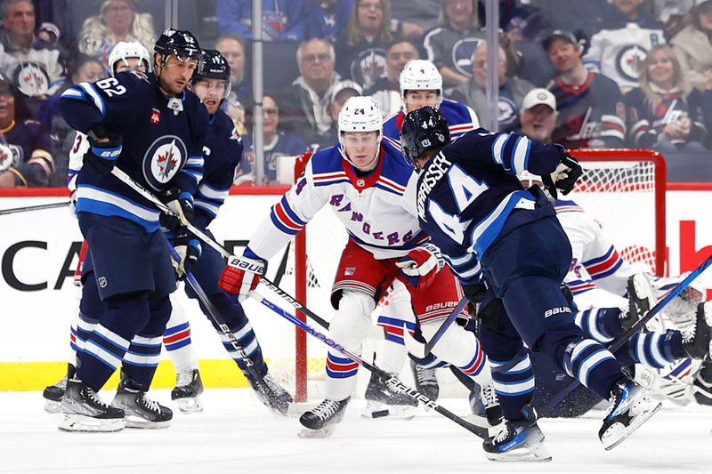 Oct 30, 2023; Winnipeg, Manitoba, CAN; Winnipeg Jets defenseman Josh Morrissey (44) has a shot blocked by New York Rangers right wing Kaapo Kakko (24) in the first period at Canada Life Centre. Mandatory Credit: James Carey Lauder-USA TODAY Sports