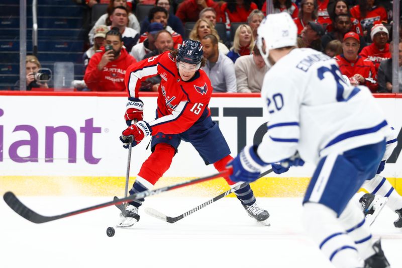 Mar 20, 2024; Washington, District of Columbia, USA; Washington Capitals left wing Sonny Milano (15) controls the puck in front of Toronto Maple Leafs defenseman Joel Edmundson (20) during the first period at Capital One Arena. Mandatory Credit: Amber Searls-USA TODAY Sports