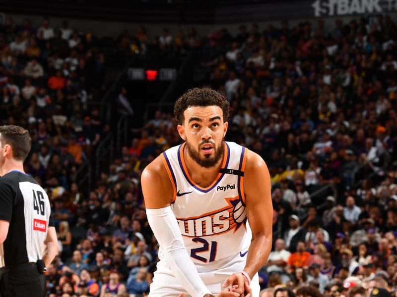 PHOENIX, AZ - OCTOBER 28: Tyus Jones #21 helps up Devin Booker #1 of the Phoenix Suns during the game against the Los Angeles Lakers on October 28, 2024 at Footprint Center in Phoenix, Arizona. NOTE TO USER: User expressly acknowledges and agrees that, by downloading and or using this photograph, user is consenting to the terms and conditions of the Getty Images License Agreement. Mandatory Copyright Notice: Copyright 2024 NBAE (Photo by Barry Gossage/NBAE via Getty Images)