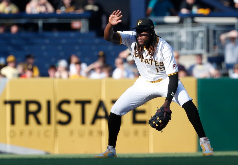 May 21, 2024; Pittsburgh, Pennsylvania, USA;  Pittsburgh Pirates shortstop Oneil Cruz (15) shields his eyes from the setting sun while in the field against the San Francisco Giants during the first inning at PNC Park. Mandatory Credit: Charles LeClaire-USA TODAY Sports