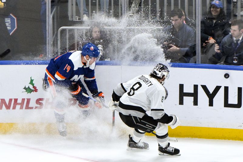 Dec 9, 2023; Elmont, New York, USA; New York Islanders center Bo Horvat (14) competes for the puck with Los Angeles Kings defenseman Drew Doughty (8) during the third period at UBS Arena. Mandatory Credit: John Jones-USA TODAY Sports