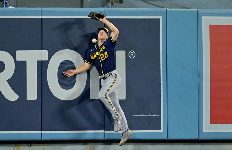 Aug 16, 2023; Los Angeles, California, USA;  A RBI double by Los Angeles Dodgers first baseman Freddie Freeman (5) gets by Milwaukee Brewers center fielder Joey Wiemer (28) in the sixth inning at Dodger Stadium. Mandatory Credit: Jayne Kamin-Oncea-USA TODAY Sports