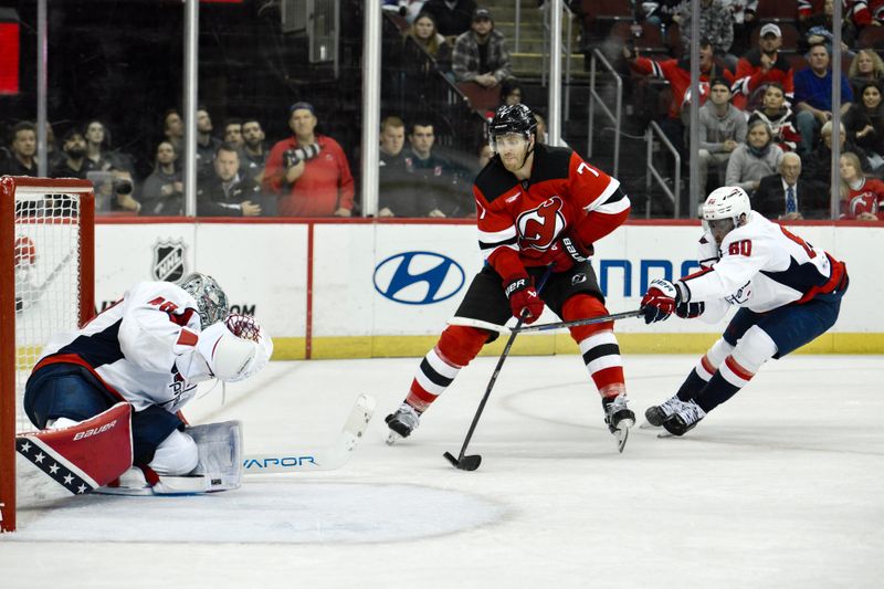 Oct 19, 2024; Newark, New Jersey, USA; New Jersey Devils defenseman Dougie Hamilton (7) prepares to shoot the puck as Washington Capitals goaltender Logan Thompson (48) and Washington Capitals left wing Pierre-Luc Dubois (80) defend during the overtime period at Prudential Center. Mandatory Credit: John Jones-Imagn Images