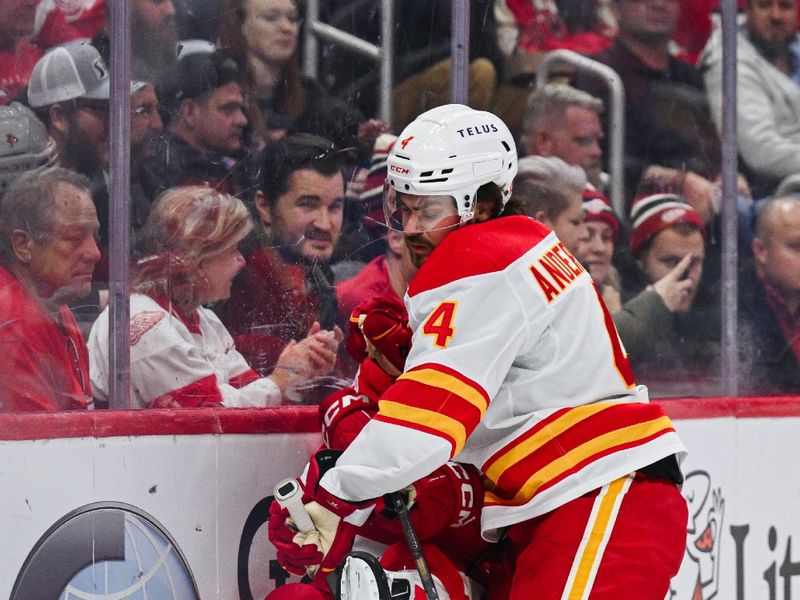 Nov 27, 2024; Detroit, Michigan, USA; Calgary Flames defenseman Rasmus Andersson (4) checks Detroit Red Wings right wing Jonatan Berggren (48) during the second period at Little Caesars Arena. Mandatory Credit: Tim Fuller-Imagn Images