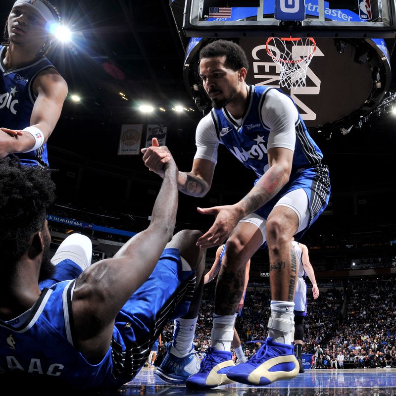 ORLANDO, FL - MARCH 23: Jonathan Isaac #1 of the Orlando Magic is helped up by Cole Anthony #50 and Paolo Banchero #5 during the game against the Sacramento Kings on March 23, 2024 at the Kia Center in Orlando, Florida. NOTE TO USER: User expressly acknowledges and agrees that, by downloading and or using this photograph, User is consenting to the terms and conditions of the Getty Images License Agreement. Mandatory Copyright Notice: Copyright 2024 NBAE (Photo by Fernando Medina/NBAE via Getty Images)